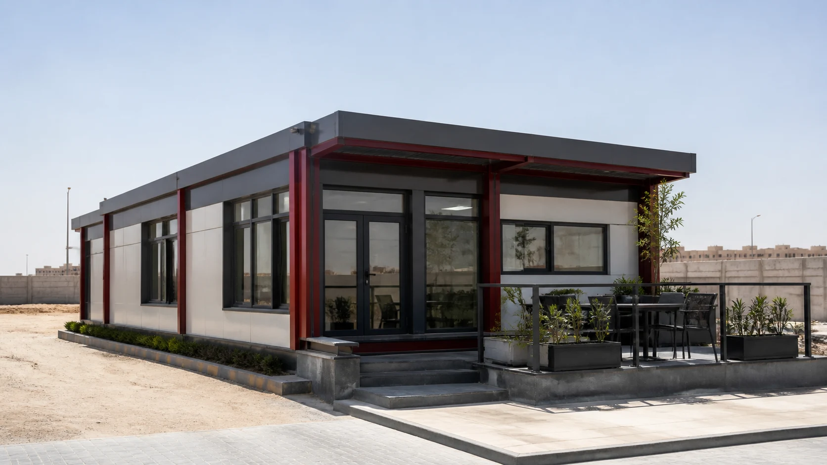Modular site office with a steel frame, broad windows and a shaded meeting terrace